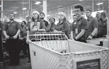  ?? LUKE SHARRETT/BLOOMBERG ?? Employees gather for a meeting before opening the doors at a Best Buy store in Louisville, Ky., on Nov. 23, 2017.