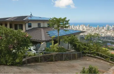  ?? CALEB JONES/AP 2015 ?? Solar panels on the roof of an off-grid home in Honolulu typify city dwellers who are exploring different ways of living.