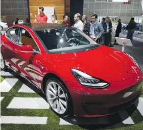  ?? PATRICK T. FALLON / BLOOMBERG FILES ?? Tesla now expects to assemble 5,000 Model 3s a week by the end of June, delaying that milestone by another three months.