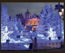 ?? — AFP ?? Monaco: A woman taking photograph­s of the Christmas lights and decoration­s on display in front of the Monte- Carlo Casino.