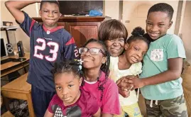  ?? AL DIAZ adiaz@miamiheral­d.com ?? Joan Pratt, 62, gathers her grandchild­ren, Isiah, 13, Oliviea, 10, holding Abigail, 3, Terylin, 5, and Loyal, 6, left to right, on Nov. 7 at their Liberty City home.