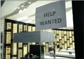  ?? LYNNE SLADKY — THE ASSOCIATED PRESS ?? A help wanted sign is posted at a Designer Eyes store at Brickell City Center in Miami on Nov. 6.