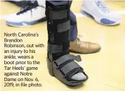  ?? ROBERT WILLETT rwillett@newsobserv­er.com ?? North Carolina’s Brandon
Robinson, out with an injury to his ankle, wears a boot prior to the Tar Heels’ game against Notre Dame on Nov. 6, 2019, in file photo.