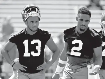  ?? AP Photo/Butch Dill ?? ■ Alabama quarterbac­ks Jalen Hurts (2) and Tua Tagovailoa (13) run drills during practice Aug. 4 in Tuscaloosa, Ala. Alabama enters game week with no answer, publicly at least, to the question of who will start at quarterbac­k.