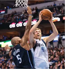  ?? (Reuters) ?? DALLAS MAVERICKS forward Dirk Nowitzki (right) scored 20 points to help lead his team to a 114-99 home victory over the Orlando Magic on Tuesday night. The 39-year-old Nowitzki went 7-for-7 from the free-throw line and is tied with Jerry West for the...