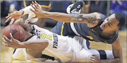  ?? [RAYMOND THOMPSON/THE ASSOCIATED PRESS] ?? West Virginia guard Jevon Carter looks to pass after stealing the ball from Coppin State guard Tre’ Thomas during the Mountainee­rs’ 77-38 victory.
STATE 38: OHIO 84, PRAIRIE VIEW 65: TOLEDO 83, JACKSON STATE 67: