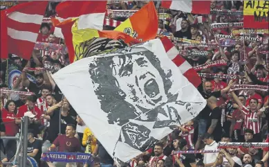  ?? Foto: EFE ?? La afición del Atlético de Madrid, con la bandera con la cara de Paulo Futre, en el Wanda Metropolit­ano