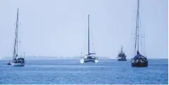  ??  ?? A Maldivian Coast Guard cutter keeps an eye on the cruiser fleet