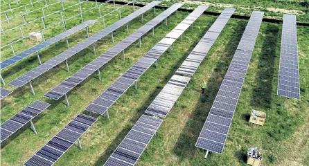  ?? Hyoung Chang, Denver Post file ?? New Energy Structures Co. crews install solar panels at Jack's Solar Garden in Longmont in July.