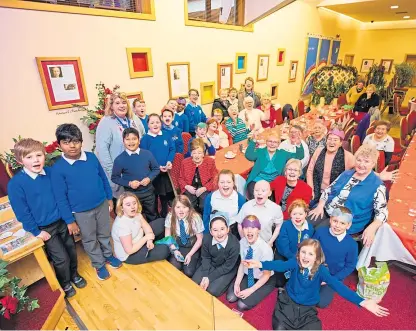  ?? Picture: Steve Macdougall. ?? Children from St Ninians P5–6–7 and head teacher Sheona Glenville-sutherland, back left, with Jane Milne, co founder and senior pastor, front right in red, and pensioners from the Letham area of Perth in the National Christian Outreach Centre, Riggs Road.