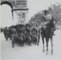  ?? AP ?? German troops march through Paris on June 14, 1940.