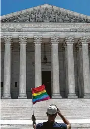  ?? New York Times file photo ?? A person waves a rainbow flag in front of the Supreme Court last June.