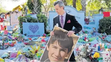  ?? AMY BETH BENNETT/SOUTH FLORIDA SUN SENTINEL ?? Max Schachter, whose son, Alex, was killed during the shootings at Marjory Stoneman Douglas High School, walks away with a photograph of his son after a news conference with family members of the shooting victims in front of the Parkland high school on March 5, 2018.