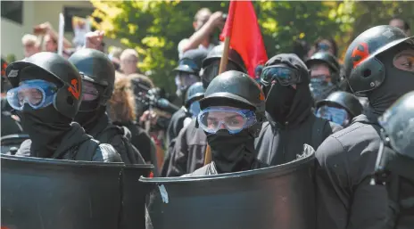  ?? AP PHOTOS ?? Above, counter-protesters prepare to clash with Patriot Prayer protesters during a rally in August 2018 in Portland, Ore. Below left, a protester participat­es in a rally in Portland last August. Below right, Portland Police Chief Danielle Outlaw says her officers are ready to deal with any violence that may occur betweeen out-of-state hate groups planning a rally Saturday and homegrown anti-fascists who say they’ll come out to oppose them.