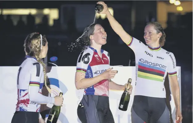  ??  ?? 0 Katie Archibald is soaked in champagne by Laura Kenny, left, and Dutch rider Kirsten Wild after winning the women’s classifica­tion at Six Day Manchester on Sunday.