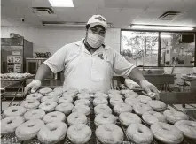  ?? Yi-Chin Lee / Staff photograph­er ?? Shipley’s Do-Nuts baker Antonio Hernandez finishes a batch Monday. Businesses looking for their second PPP loan will not be able to apply untilWedne­sday.