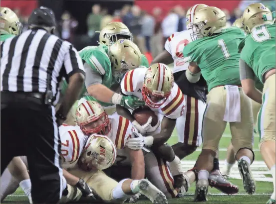  ?? Jeremy Stewart / Rome News-Tribune ?? Rome’s Jamious Griffin leaps over a group of players to get a first down in the second quarter of the Class 5A state championsh­ip game Friday at the Georgia Dome.