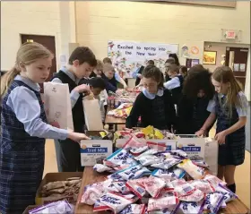  ?? PHOTO FROM ST. TERESA OF CALCUTTA PARISH SCHOOL ?? Students at St. Teresa of Calcutta Parish School in Limerick load up breakfast bags to donate to Open Door Ministry in Royersford.