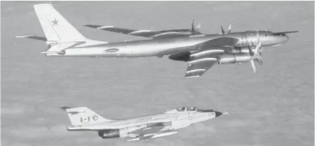  ??  ?? An undated photo shows a Royal Canadian Air Force CF-101 Voodoo jet intercepti­ng a Soviet Union TU-95 Bear Bomber flying near the buffer zone that Norad monitors around the North American continent. The precise location of the intercept was not...