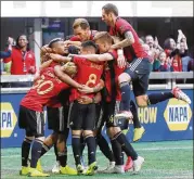  ?? CURTIS COMPTON / CCOMPTON@AJC.COM ?? Teammates mob Franco Escobar after his goal gave Atlanta United a 1-0 lead over Chicago on Sunday. The right-footed Escobar said it was the first goal he has scored with his left foot.