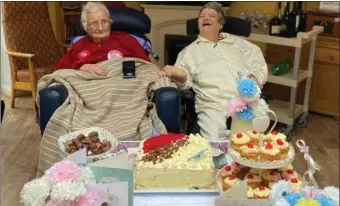  ??  ?? Loretta Dooley enjoying her 104th birthday party with her daughter, Maria.