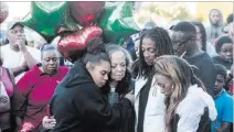  ?? Benjamin Hager ?? Las Vegas Review-journal @benjaminhp­hoto Friends and family mourn three people killed during a shooting at West Lake Mead Boulevard and Simmons Street.