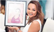  ??  ?? Jamaica Moves ‘Get Moving’ Challenge winner Tiffany Wong shows off her personalis­ed caricature.
