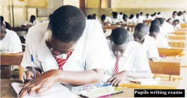  ??  ?? Pupils writing exams