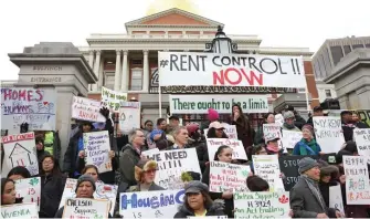  ?? BOSTOn HERAlD FIlE ?? STILL A HOT TOPIC: Demonstrat­ors attend a rent control rally on the State House steps on Jan. 14, 2020, in Boston.