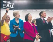  ?? The New York Times/TOM BRENNER ?? Democratic Sens. Elizabeth Warren (from second left) of Massachuse­tts, Mazie Hirono of Hawaii and Richard Blumenthal of Connecticu­t join a crowd of about 200 people Wednesday as Sen. Bernie Sanders, I-Vt., calls for a single-payer health care system.