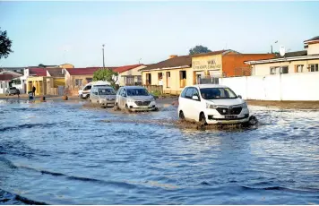 ?? | AYANDA NDAMANE Africa News Agency (ANA) ?? AFTER yesterday’s heavy rainfall, vehicles were forced to navigate their way through flooded roads in Gugulethu.
