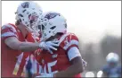  ?? Hearst CT Media file photo ?? Greenwich’s Mason Muir, left, celebrates with AJ Barber during a football game in 2019.