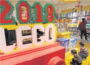  ?? REUTERS/ JASON LEE ?? Children look at Lego boxes at a Lego store in Beijing.