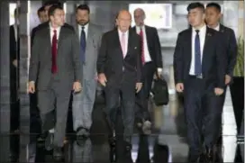  ?? MARK SCHIEFELBE­IN — THE ASSOCIATED PRESS ?? U.S. Commerce Secretary Wilbur Ross, center, leaves his hotel in Beijing, Saturday. U.S. Commerce Secretary Ross has arrived in Beijing for talks on China’s promise to buy more American goods after Washington revived tensions by renewing its threat of...