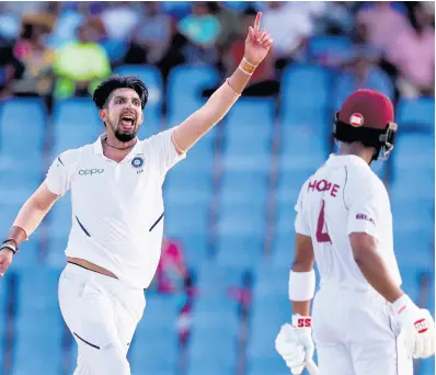  ?? AP ?? India’s Ishant Sharma (left) celebrates taking the wicket of Windies’ Shai Hope during day two of the first Test match at the Sir Vivian Richards cricket ground in North Sound, Antigua and Barbuda yesterday.