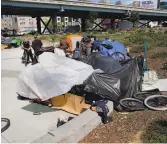  ?? Brant Ward / The Chronicle ?? Makeshift shelters serve as housing at Fifth and Bryant streets, near the current St. Vincent de Paul homeless shelter and future developmen­t.