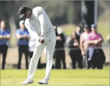  ?? AP PHOTO/RYAN KANG ?? Tiger Woods hits from the 11th fairway during the first round of the Genesis Invitation­al golf tournament at Riviera Country Club on Thursday in the Pacific Palisades area of Los Angeles.