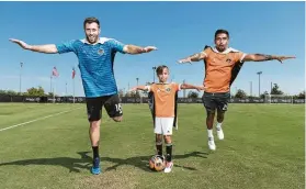  ?? Wilf Thorne / Houston Dynamo ?? Dynamo players Chris Seitz, left, and A.J. DeLaGarza don superhero capes for the Kick Childhood Cancer game.