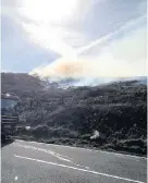  ?? Matthew Rowlands ?? > Firefighte­rs at the scene of a deliberate grass fire in Caerau, Maesteg, on Sunday