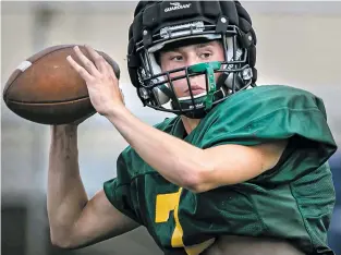  ?? JIM WEBER/THE NEW MEXICAN ?? Quarterbac­k Jacob Green looks for an open receiver during practice Wednesday at Sullivan Field in Los Alamos. Green is back after being sidelined last season by a compound fracture in his left leg.