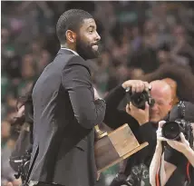  ?? AP PHOTO ?? FOCAL POINT: Kyrie Irving receives the Red Auerbach Award before last night’s Game 5 between the Celtics and Bucks at the Garden.