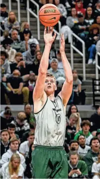  ?? NICK KING/LANSING STATE JOURNAL ?? Michigan State’s Jaxon Kohler makes a shot during the Michigan State Madness event on Oct. 13 at the Breslin Center in East Lansing.