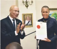  ??  ?? Fayval Williams receives her instrument of appointmen­t from Governor General Sir Patrick Allen.