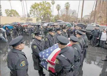  ?? Photograph­s by Irfan Khan Los Angeles Times ?? THE PROCESSION for Pomona Officer Greggory Casillas prepares to leave Purpose Church. Hundreds attended the service Thursday, including Gov. Jerry Brown and uniformed officers from multiple agencies.