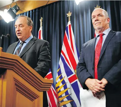  ?? CHAD HIPOLITO/THE CANADIAN PRESS ?? Green Leader Andrew Weaver and Premier John Horgan announce the Election Amendment Act on Monday. The bill will deliver more than $30 million in taxpayer cash to B.C.’s major political parties over the next five years.