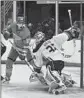  ?? Jeff Le Associated Press ?? DUCKS GOALIE John Gibson, right, eyes the puck against the Blues’ Alexey Toropchenk­o.