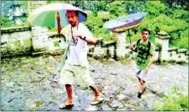  ??  ?? SHAUN Livingston from Shoreditch, was snapped braving the monsson when he visited Tam Coc, Vietnam last August. Shaun said: “We were hiking up a mountain in treacherou­s weather, and had bought umbrellas from our hotel for about 20p. Some coped better...