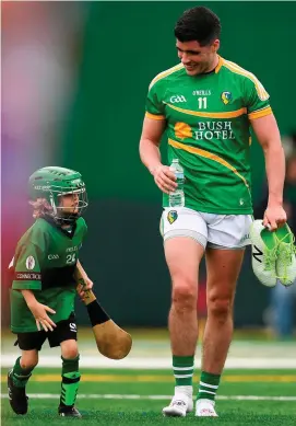  ?? STEPHEN McCARTHY / SPORTSFILE ?? Emlyn Mulligan has a new fan as he leaves the pitch at half-time during Leitrim’s match against New York at Gaelic Park