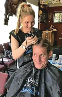  ?? Picture: SUPPLIED ?? MAKING A DIFFERENCE: Tamlyn Hartley shaved the head of Hilton de Bruyn during the annual Shaveathon in aid of Cansa hosted by Round Table No 16 at the Queenstown Golf Club on Friday