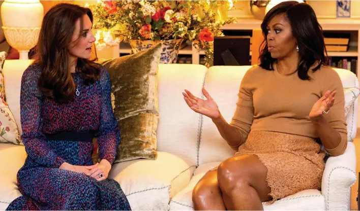  ??  ?? Girl talk: Kate chats with an animated Michelle Obama in the drawing room at the young royals’ Kensington Palace apartment before dinner last night